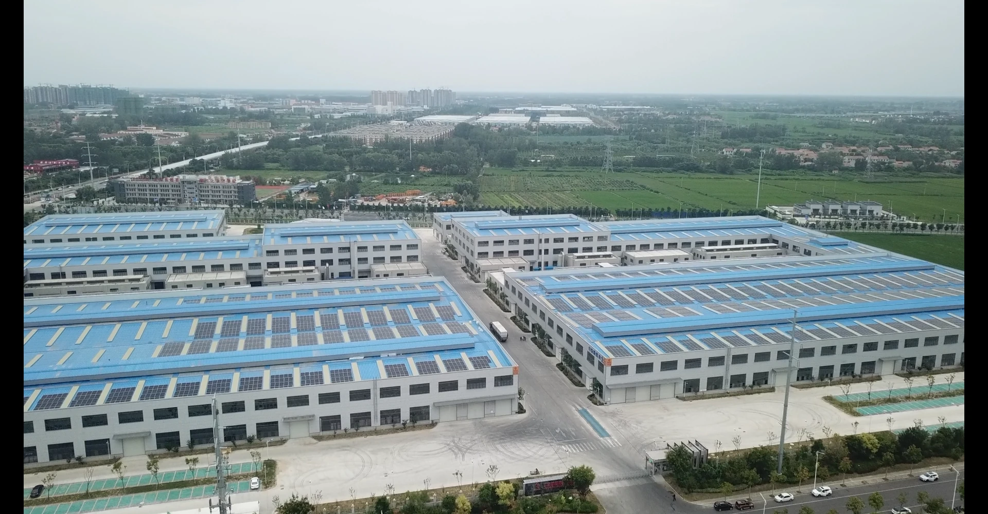 Aerial panoramic view of LSW forged wheel manufacturing park and blue factory roof