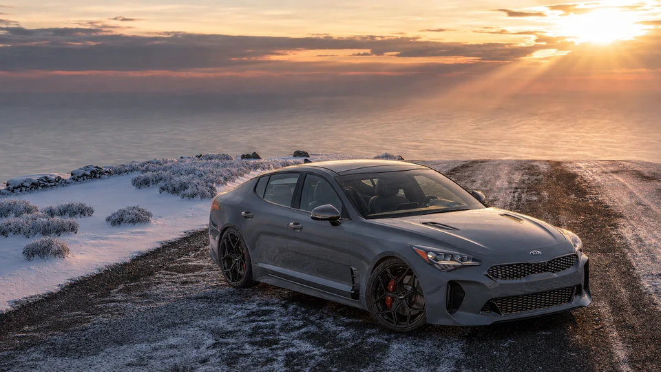 Kia Stinger with black LSW forged wheels on a snowy coastal road